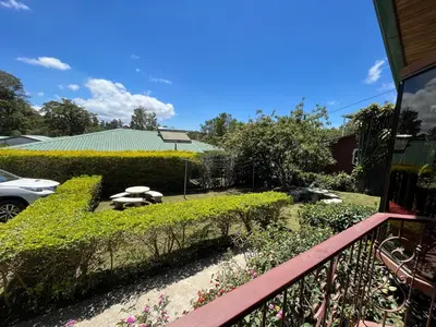 a view of a garden from the balcony of a house at TucanTico Lodge - Monteverde in Monteverde Costa Rica