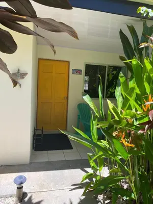 a front door of a house with green plants at Cote Pacific Casitas in Huacas