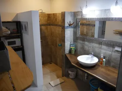 a bathroom with a sink and a shower at Cote Pacific Casitas in Huacas