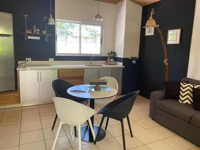 a kitchen and living room with a table and chairs at Cote Pacific Casitas in Huacas