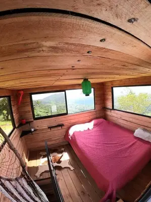 an overhead view of a bed in a room with windows at Alto Luciérnaga in Guayacán