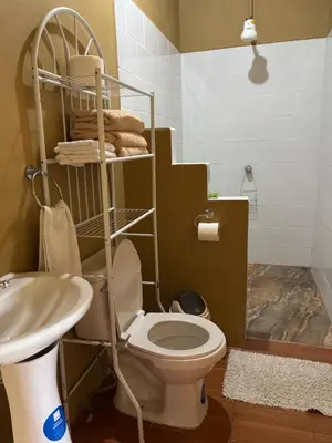 a bathroom with a toilet and a sink at OXÍGENO Río Celeste in Bijagua