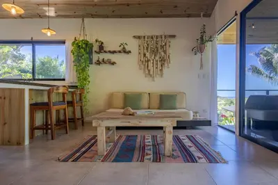 a living room with a couch and a table at Private Casita Jungle Treehouse Ocean View in Uvita