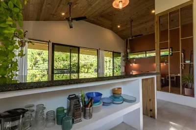 a kitchen with a counter with dishes on it at Private Casita Jungle Treehouse Ocean View in Uvita