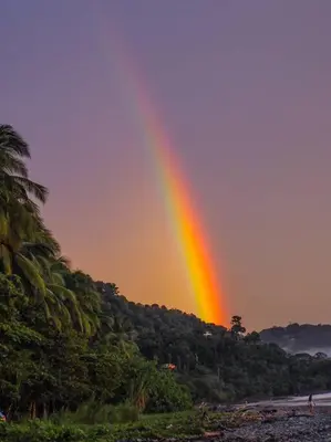 a rainbow in the sky over a river at Private Casita Jungle Treehouse Ocean View in Uvita