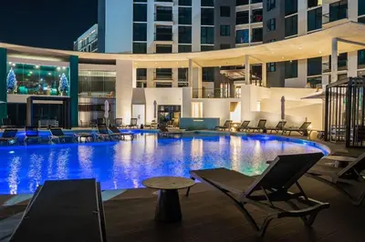 a large swimming pool in a hotel at night at Nucleo 514 in San José