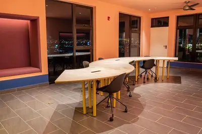 a conference room with wooden tables and chairs in a building at Nucleo 514 in San José