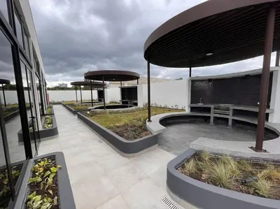 a patio with two large umbrellas on a building at Nucleo 514 in San José