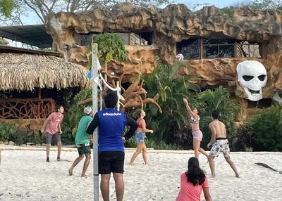 a group of people playing a game on the beach at La Perla Negra Eco Pirate Resort in Puntarenas