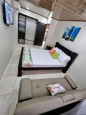 a small bedroom with a couch and a bed at Department H González 2 in Alajuela City