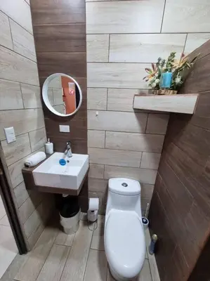 a bathroom with a toilet and a sink at Department H González 2 in Alajuela City