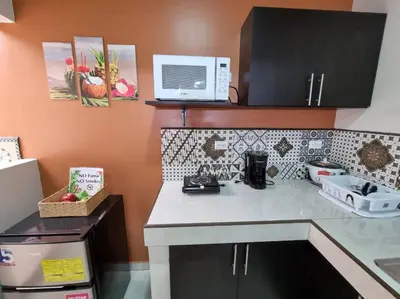 a kitchen with a counter top with a microwave at Department H González 2 in Alajuela City