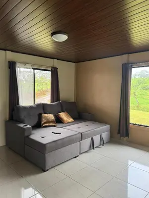 a living room with a couch and a window at Casa Esperanza in Río Cuarto