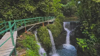 a bridge over a waterfall next to a river at Casa Esperanza in Río Cuarto