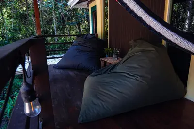 two pillows on the porch of a tree house at Miles Away in Cóbano