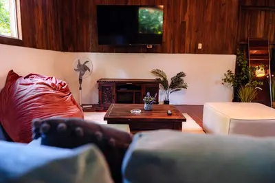 a living room with a couch and a table at Miles Away in Cóbano