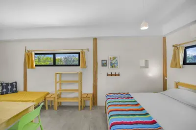 a bedroom with a bed and a desk and a chair at Casas Teresa Mar in Santa Teresa Beach