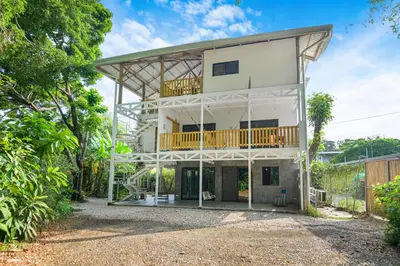 a large white house with a balcony at Casas Teresa Mar in Santa Teresa Beach