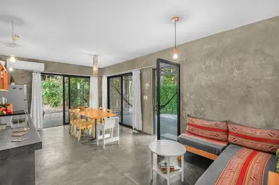 a living room with a couch and a table at Casas Teresa Mar in Santa Teresa Beach