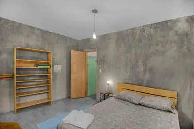 a bedroom with a bed and a book shelf at Casas Teresa Mar in Santa Teresa Beach