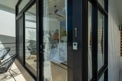 a glass door of a house with a balcony at L'Avventura in Tamarindo