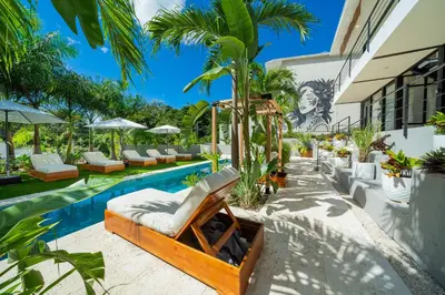 a swimming pool with lounge chairs and a resort at L'Avventura in Tamarindo