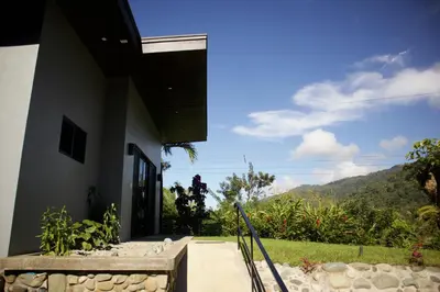 a house with a view of a mountain at Jungle Home with King Beds -5 Minutes from the Beach in Uvita