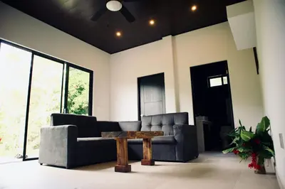 a living room with a couch and a coffee table at Jungle Home with King Beds -5 Minutes from the Beach in Uvita