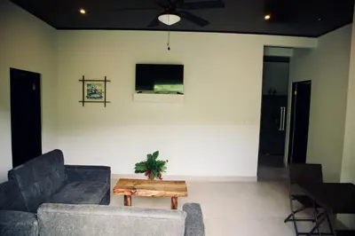 a living room with two couches and a table at Jungle Home with King Beds -5 Minutes from the Beach in Uvita