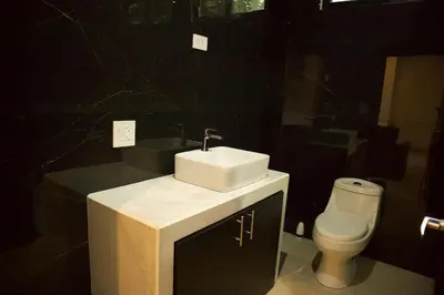 a bathroom with a sink and a toilet at Jungle Home with King Beds -5 Minutes from the Beach in Uvita