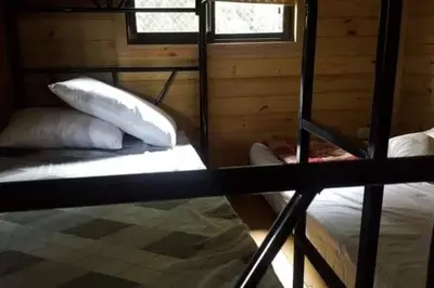 a bedroom with two bunk beds and a window at Villa Cola de Ballena Uvita in Uvita