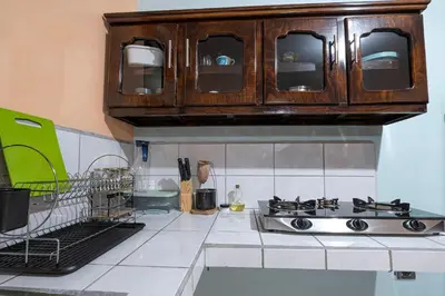 a kitchen with a sink and wooden cabinets at Jordi´s House in Fortuna