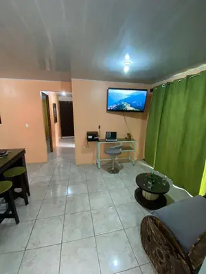 a living room with a tv on the wall at Jordi´s House in Fortuna