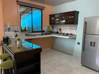 a kitchen with a refrigerator and a counter top at Jordi´s House in Fortuna
