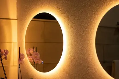 a lighted wall with a mirror in a bathroom at Gamai Full House Monteverde in Monteverde Costa Rica
