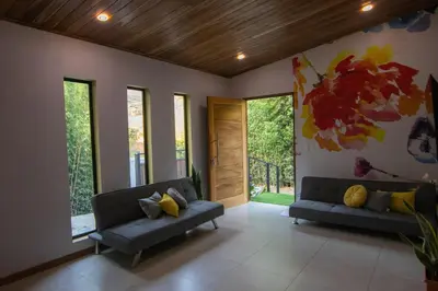 a living room with two couches and a painting on the wall at Gamai Full House Monteverde in Monteverde Costa Rica
