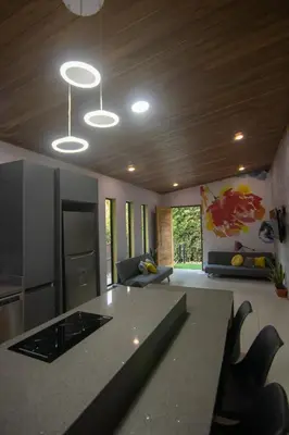 a kitchen and living room with a table and chairs at Gamai Full House Monteverde in Monteverde Costa Rica