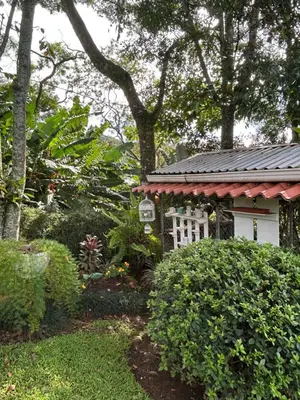 a garden with a house with a sign on it at Eco Villas Tambor Tucanes in Tambor