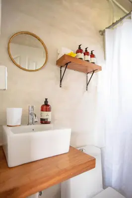 a bathroom with a sink and a mirror on the wall at Buen Camino Hotel, San Mateo in San Mateo