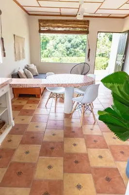 a living room with a table and chairs at Buen Camino Hotel, San Mateo in San Mateo