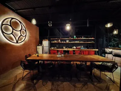 a large wooden table in a room with chairs at CASA FOTR LOCO in Uvita