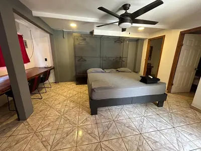a bedroom with a bed and a ceiling fan at CASA FOTR LOCO in Uvita