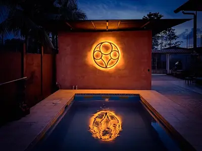 a swimming pool with a sign on the side of a house at CASA FOTR LOCO in Uvita
