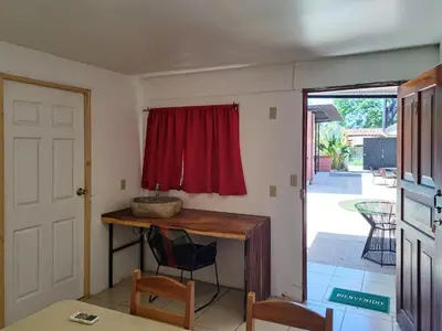 a room with a table and a red curtain at CASA FOTR LOCO in Uvita