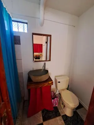 a bathroom with a sink and a toilet at CASA FOTR LOCO in Uvita