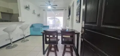 a kitchen with a table and chairs in a room at Herradura Home 2 in Herradura