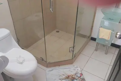 a bathroom with a shower and a toilet at Herradura Home in Herradura