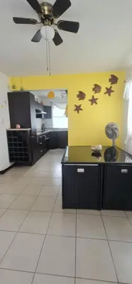a kitchen with a ceiling fan in a room at Herradura Home in Herradura