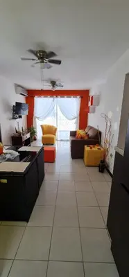 a living room with a couch and a table at Herradura Home in Herradura