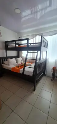 a black bunk bed in a room at Herradura Home in Herradura